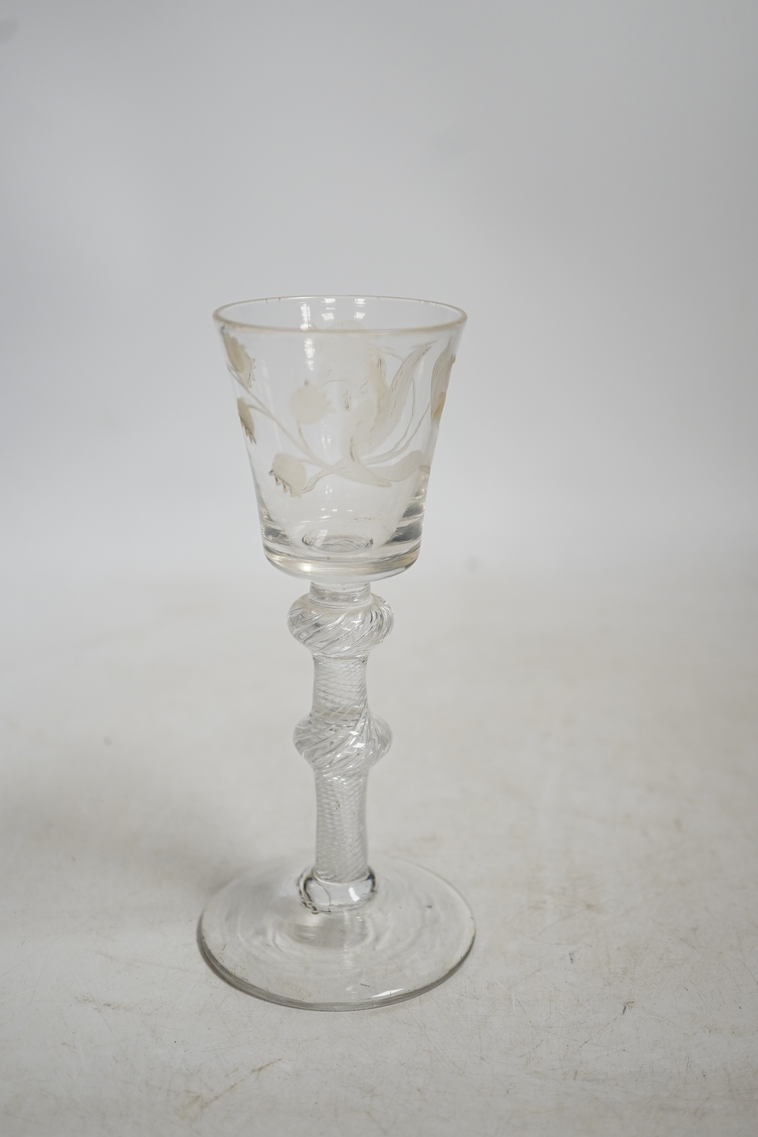 A mid 18th century air twist stem cordial glass with later engraved decoration, 15.5cm high. Condition - fair